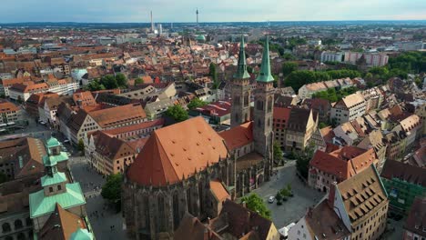 4k aerial drone video of the twin spiers and stained glass windows of the beautiful st. sebald church in downtown nurnberg, germany