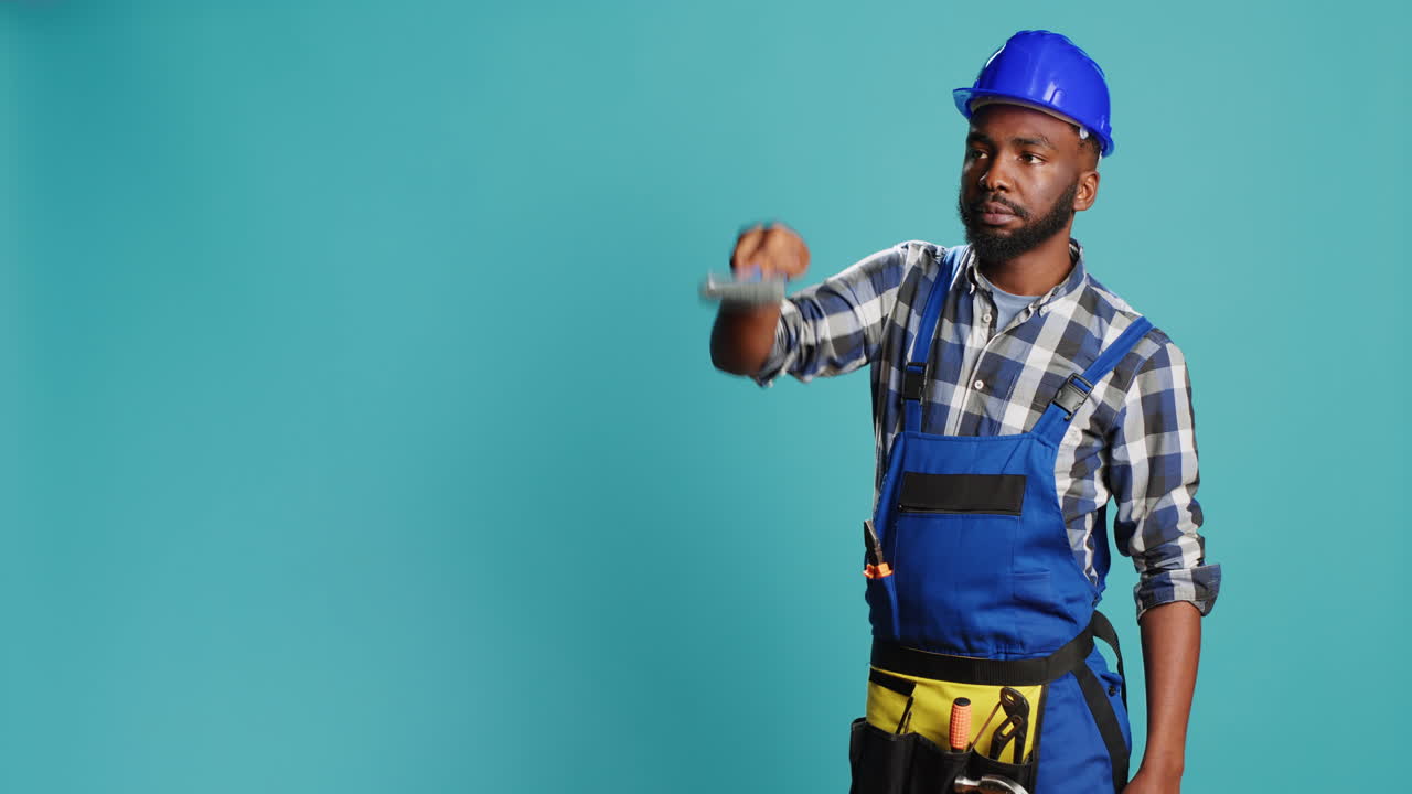African american man painting walls with brush