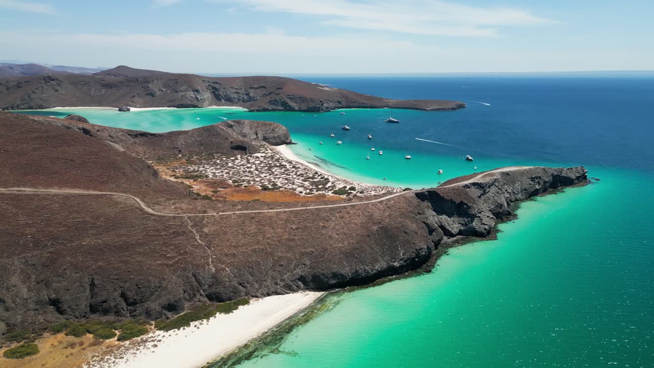 Coastal landscape in La Paz, Tecolandra, Mexico with clear turquoise waters and boats
