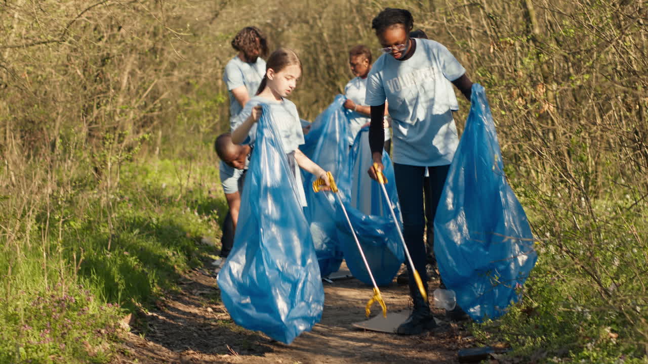Group of volunteers working to clean the forest from garbage