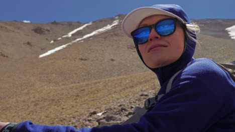 Tourist-girl-on-a-hike-watching-the-landscape-of-High-Atlas,-Morocco,-close-up