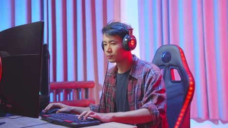 young man gaming on a computer