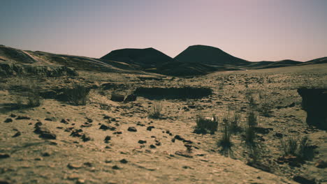 a wide shot of a desert landscape with mountains in the distance.