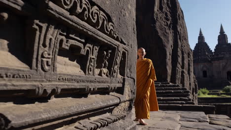 a monk explores ancient temple ruins with stone carvings