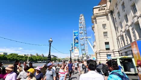 crowds gather near iconic ferris wheel attraction