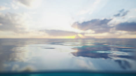 a beautiful view of the ocean with a sunset in the background