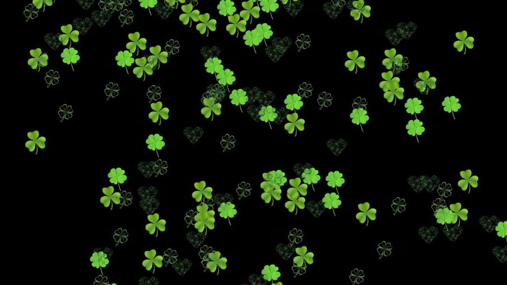 Animation of green clovers falling on black background for St. Patricks day