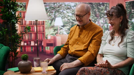 Old-man-and-woman-throwing-their-effervescent-vitamin-pills-in-a-glass-of-water