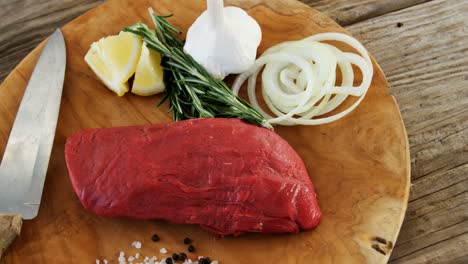 Loaf-of-sirloin-meat-and-ingredients-on-wooden-board