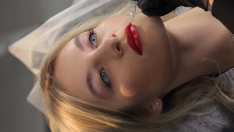 woman undergoing permanent lip makeup procedure