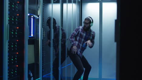 energetic it professional dances in a server room