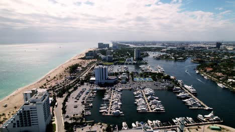 aerial drone shot buildings beach blue water blue sky palm trees ft