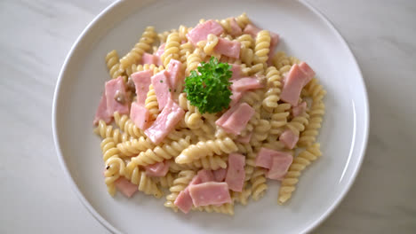 spirali or spiral pasta mushroom cream sauce with ham - italian food style