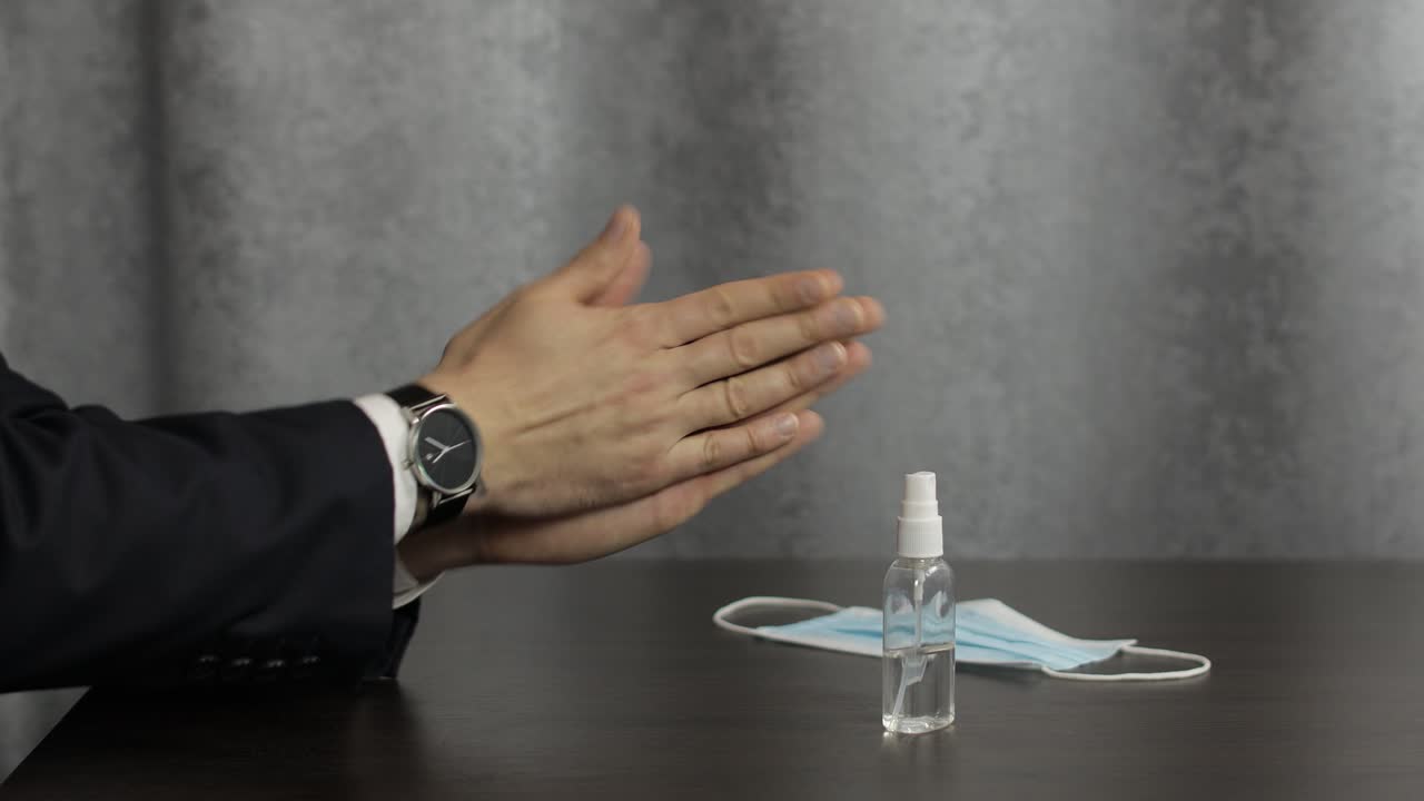 Hombre usando botella de desinfectante en spray de alcohol líquido en las manos. Coronavirus