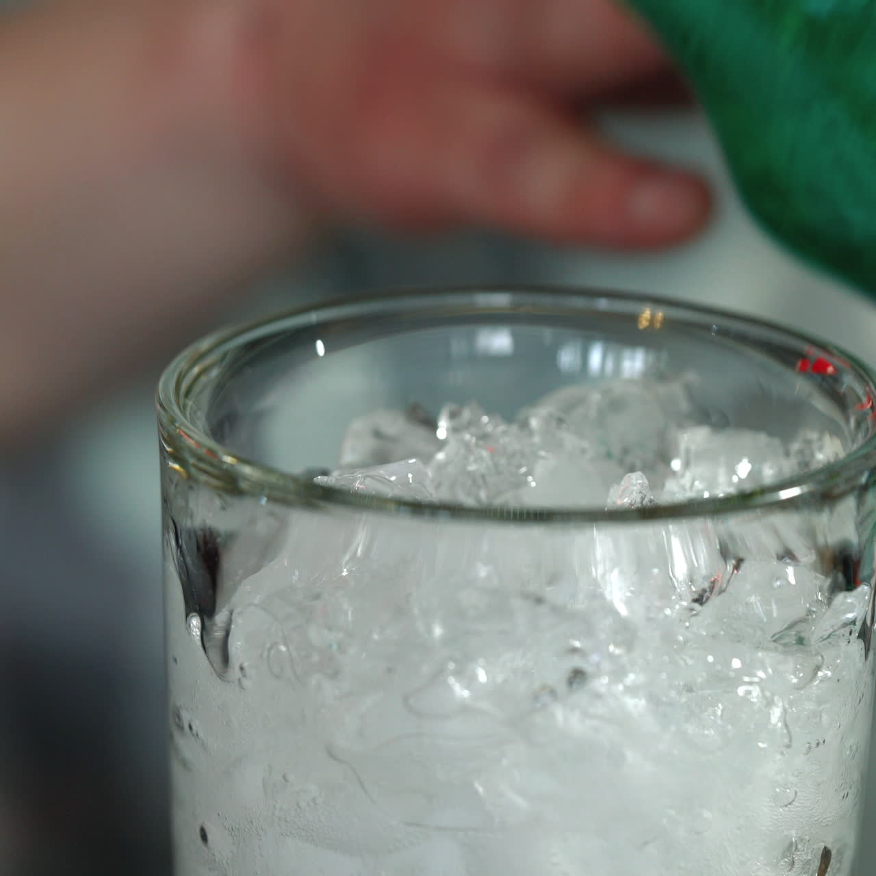 Barman makes a cocktail over the bar counter. Process of preparing a non-alcoholic cocktail. Sqare video