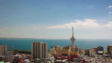 beppu city and tower with ocean in background, kyushu japan establishing shot