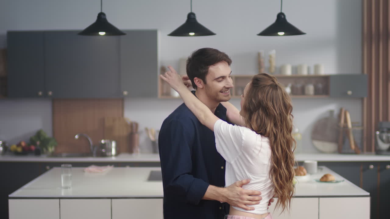 Loving couple dancing slowly in the kitchen