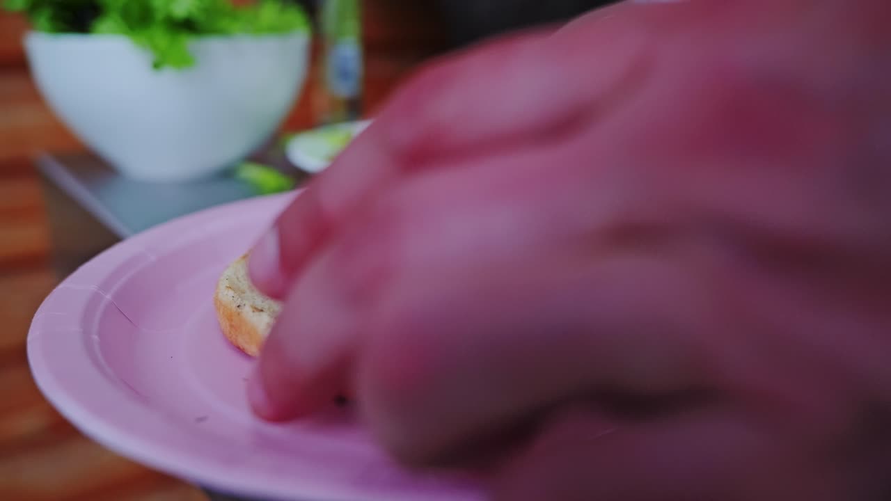 Hot grilled patty with melted cheese drops onto sauced bun in cozy backyard