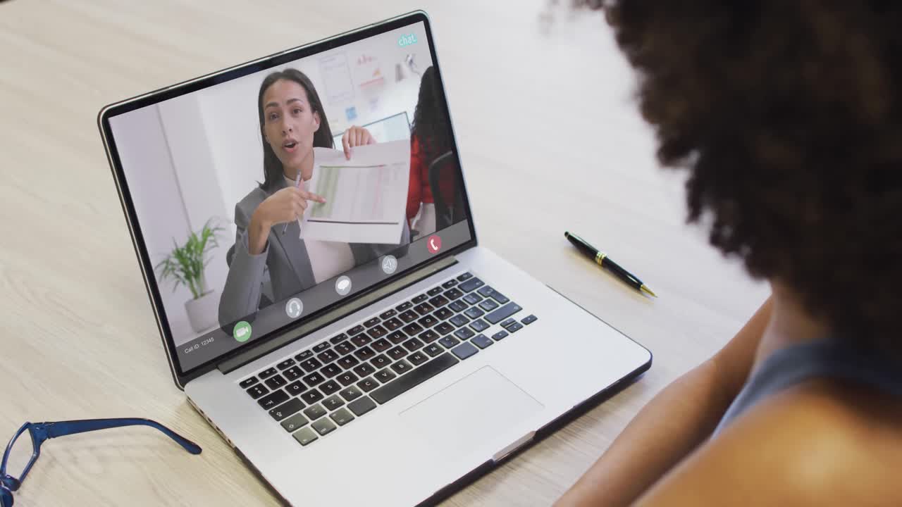 African american businesswoman using laptop for video call with biracial business colleague