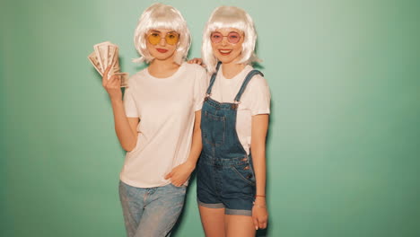 two stylish women with money