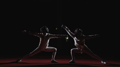 two fencers in action during a competition