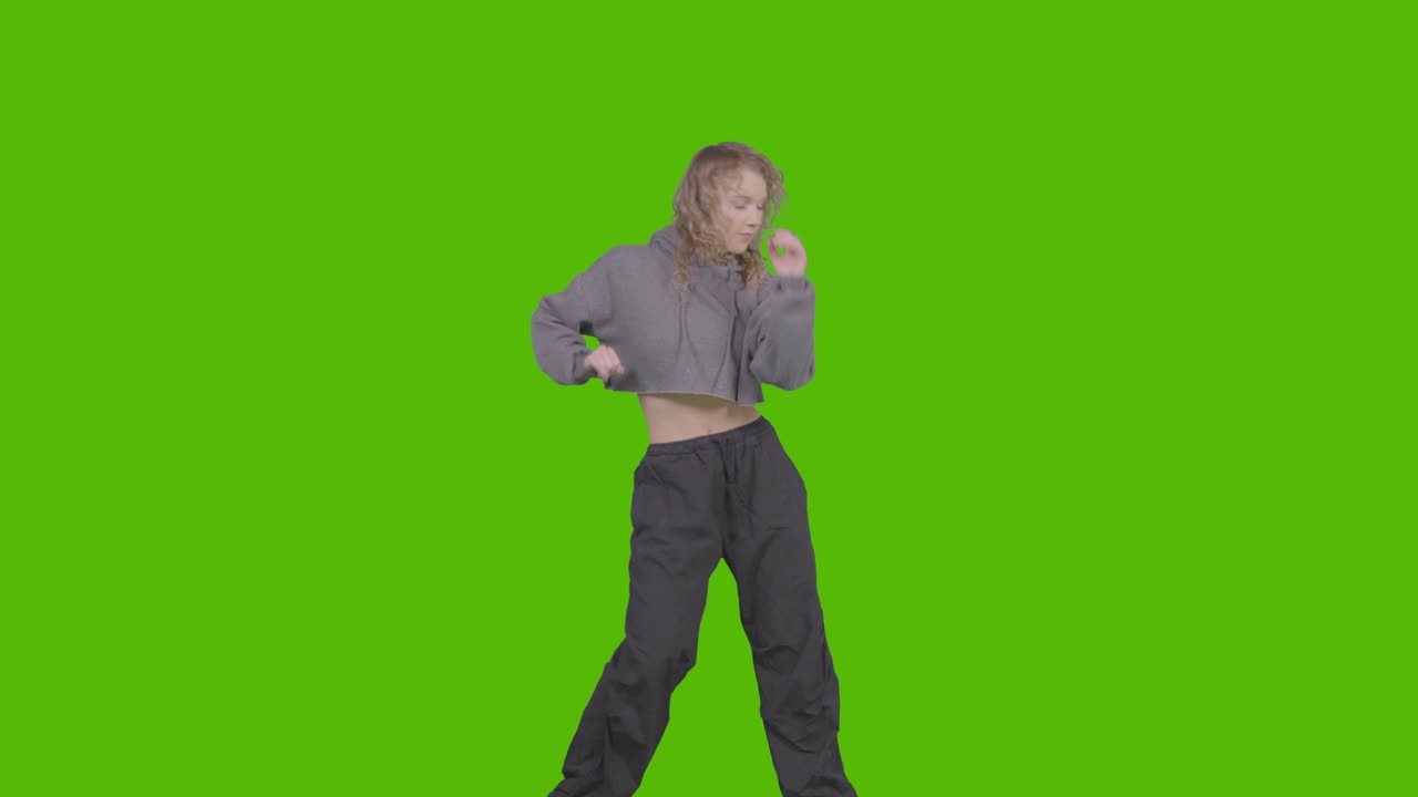Studio Shot Of Young Woman Having Fun Dancing Against Green Screen 30