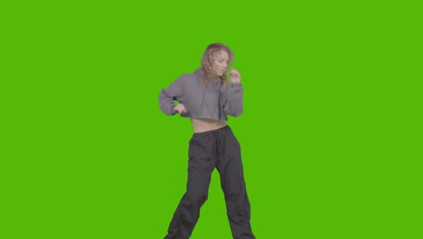 studio shot of young woman having fun dancing against green screen 30