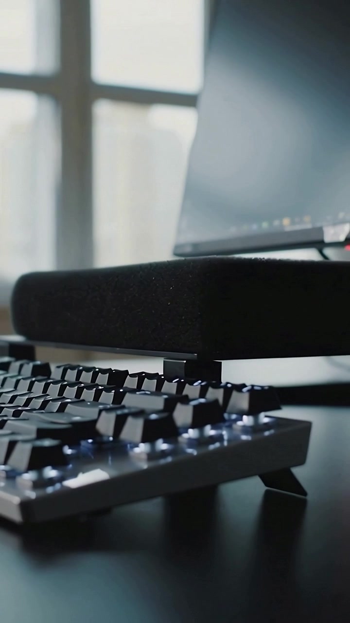 Video verticale: Telecamera panoramica che si muove sulla scrivania dal monitor ai tasti illuminati e al poggiapolsi per evidenziare