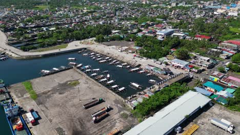 scenic aerial pullback of a docking port for filipino bangka fishing boats at tabaco port, albay, philippines.