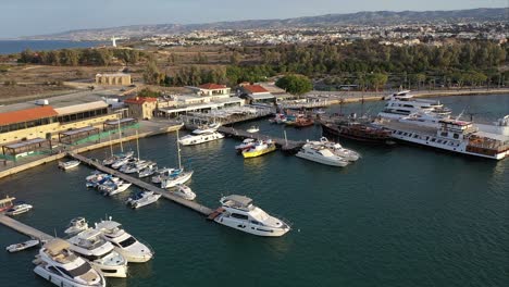 wide aerial establishing show of boats docked at the port of pafos in the earl morning