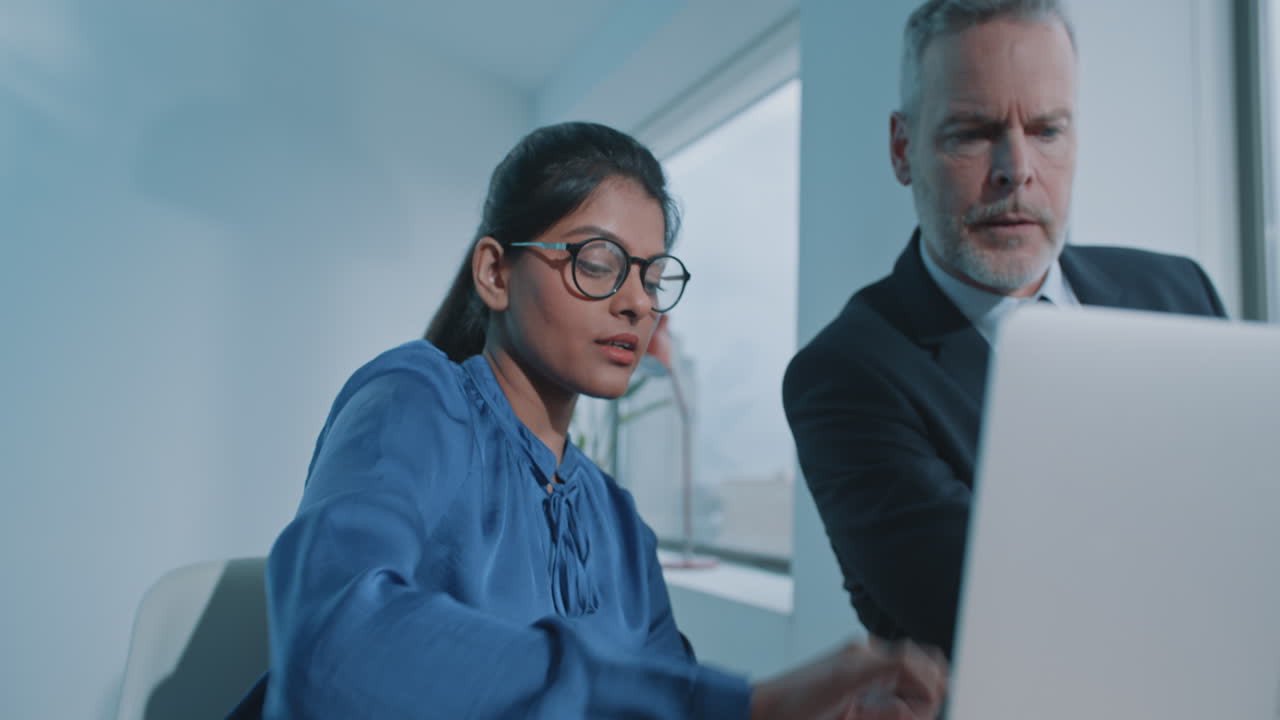 Business Colleagues Collaborating on Laptop