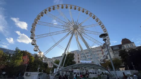 budapest, hungary - the budapest eye ferris wheel is spinning at deak square