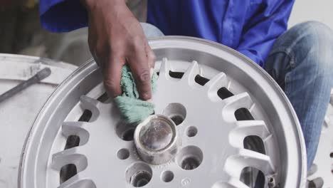 african man cleaning a wheel