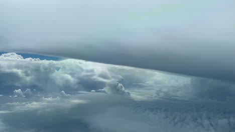 impressive pilot pov flying near a massive cumulonimbus storm cloud in a threatening stormy sky