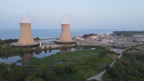 enrico fermi ii nuclear power plant with steaming chimneys, aerial drone view