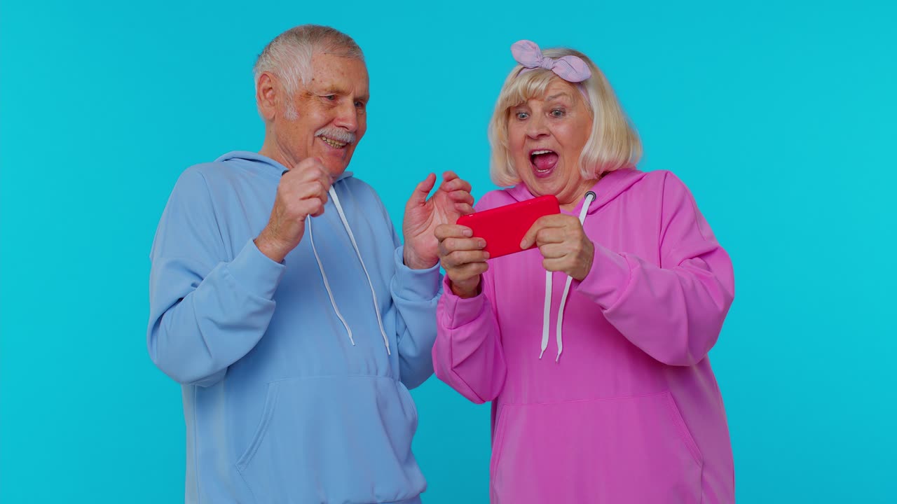 Senior Couple Excitedly Looking at Phone Together