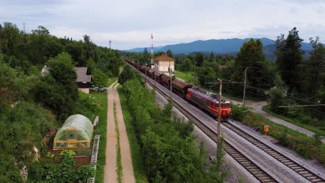 Transportation-scene-of-freight-train-locomotive-and-wagons-passing-in-Croatia-rural,-Europe