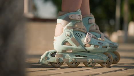 close-up leg view of individual rolling forward and backward on interlocked ground in roller skates, then gently stamping ground, showcasing fluid movements of roller skating