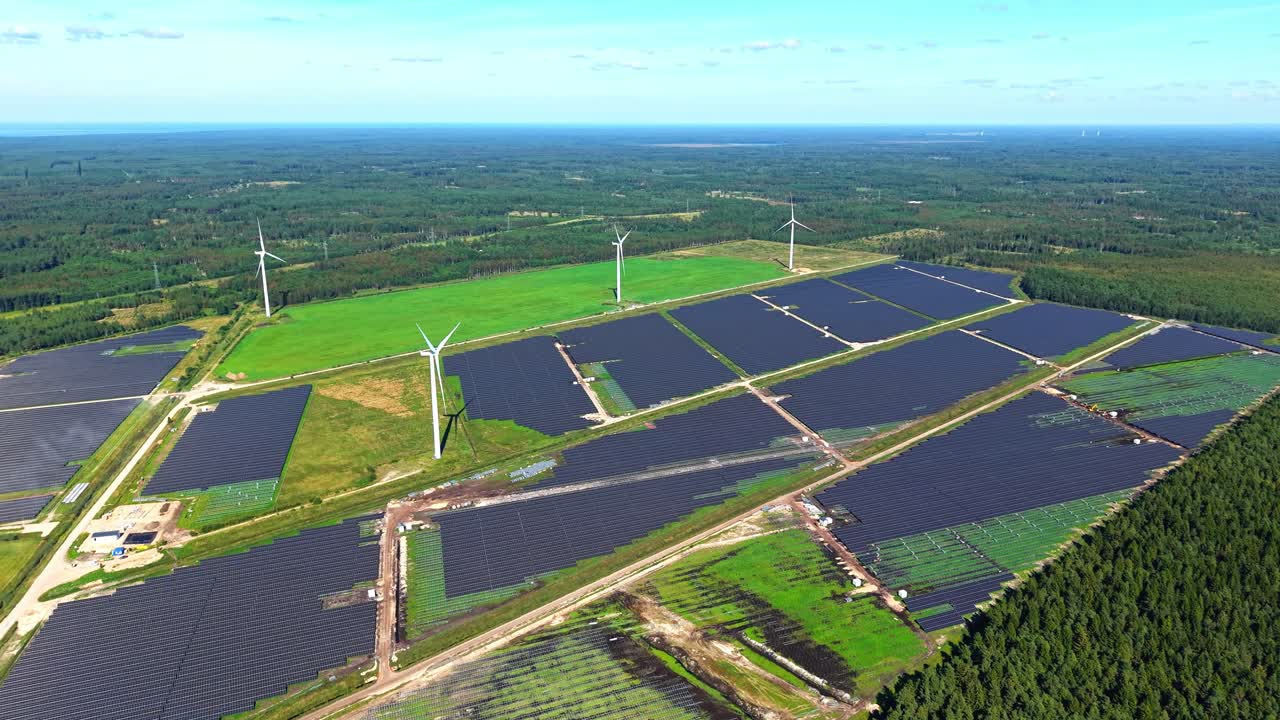 Wind turbines and solar panels in a green landscape view