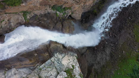 tiro aéreo en ángulo descendente cascada barskoon en el cañón de cuento de hadas en kirguistán, imágenes cinematográficas de drones