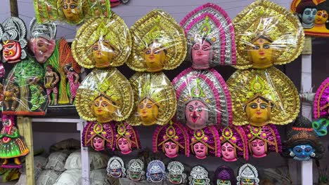 Panorama-shot-of-various-facemasks-being-displayed-at-roadside-stall-in-Purulia,-India