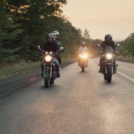 bikers ride motorcycles with lights turned