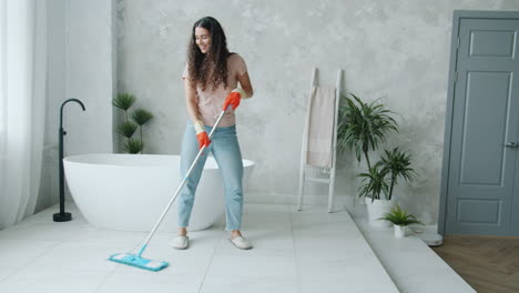 woman mopping a bathroom floor