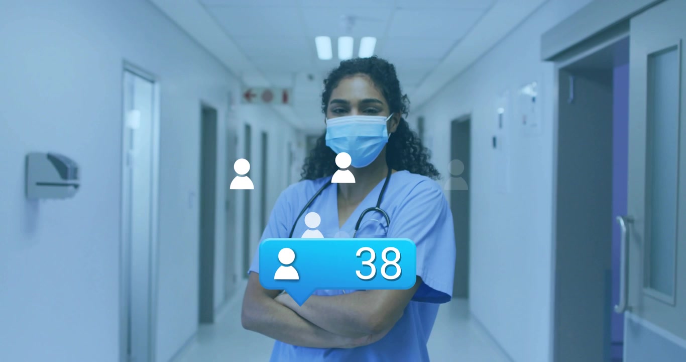 Infermiera che muove le braccia nel corridoio dell'ospedale attivando una bolla UI che aumenta il numero di utenti con icone fluttuanti.