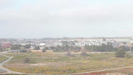 aerial view captures golden coastline near fort ord beach, with highway 1 stretching quietly in the distance.