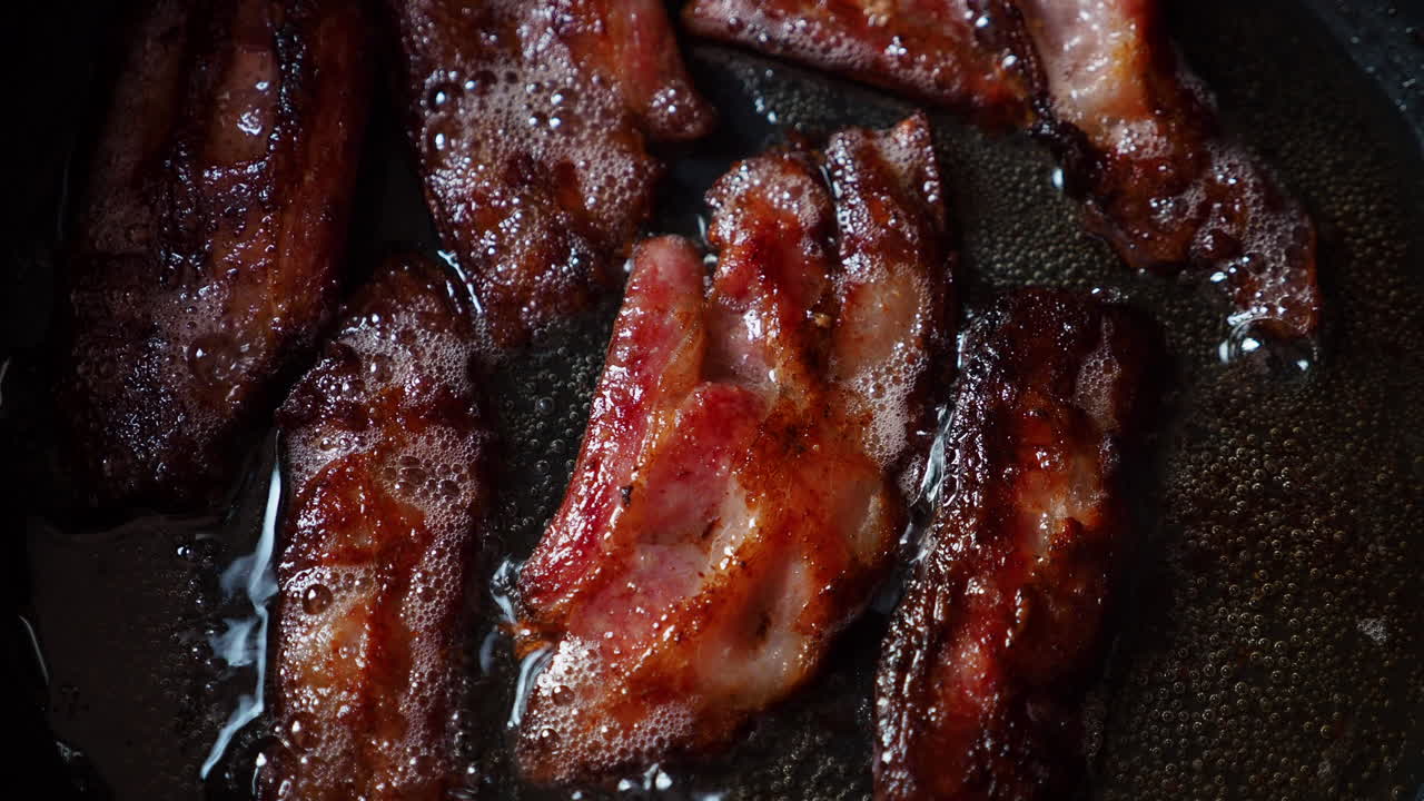 Frying crispy bacon in a pan. Cooking meat