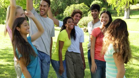 Group-of-casual-young-friends-putting-their-hands-together