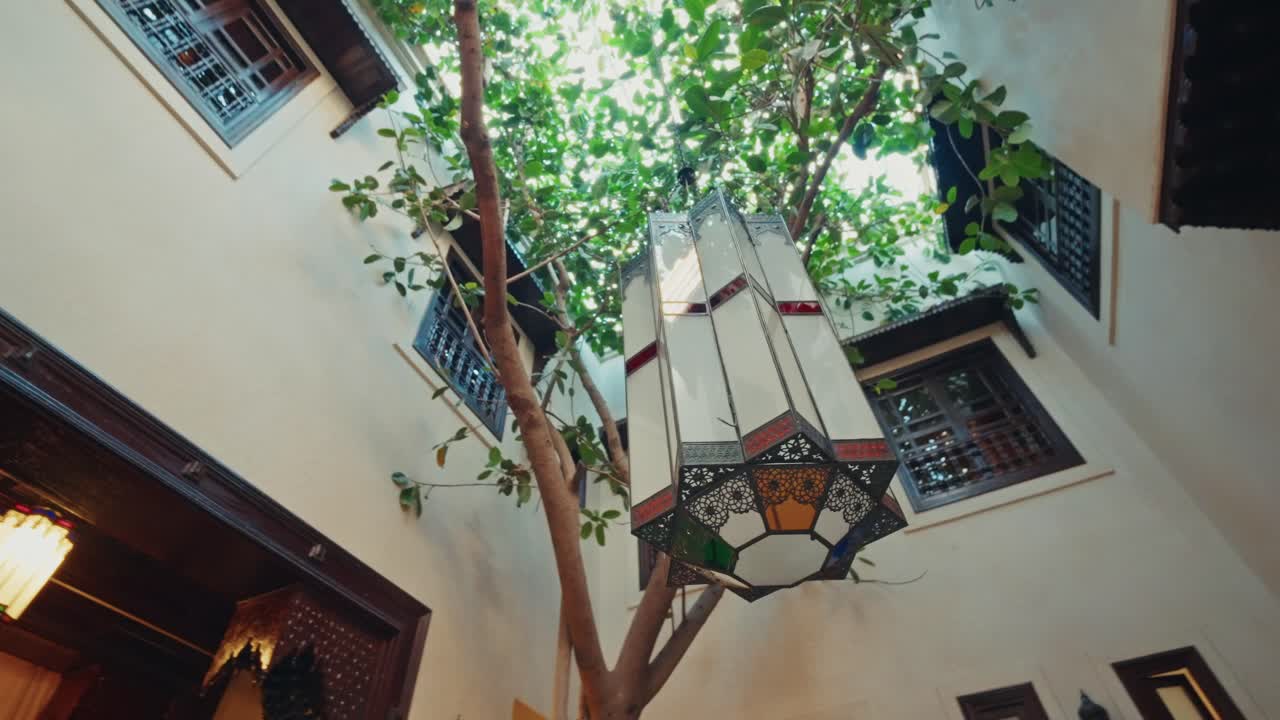 Panoramic overview inside a traditional Riad in Marrakesh, Morocco. View of the beautiful interior decorations and the traditional moroccan architecture.