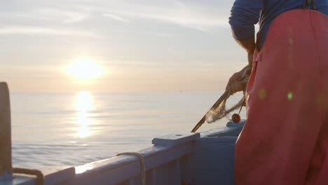 Fisherman-on-Boat-at-Dawn-with-Sunrise-Over-the-Ocean