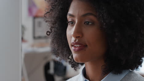 young mixed race business woman using computer brainstorming problem solving idea looking pensive thinking of solution in office workplace